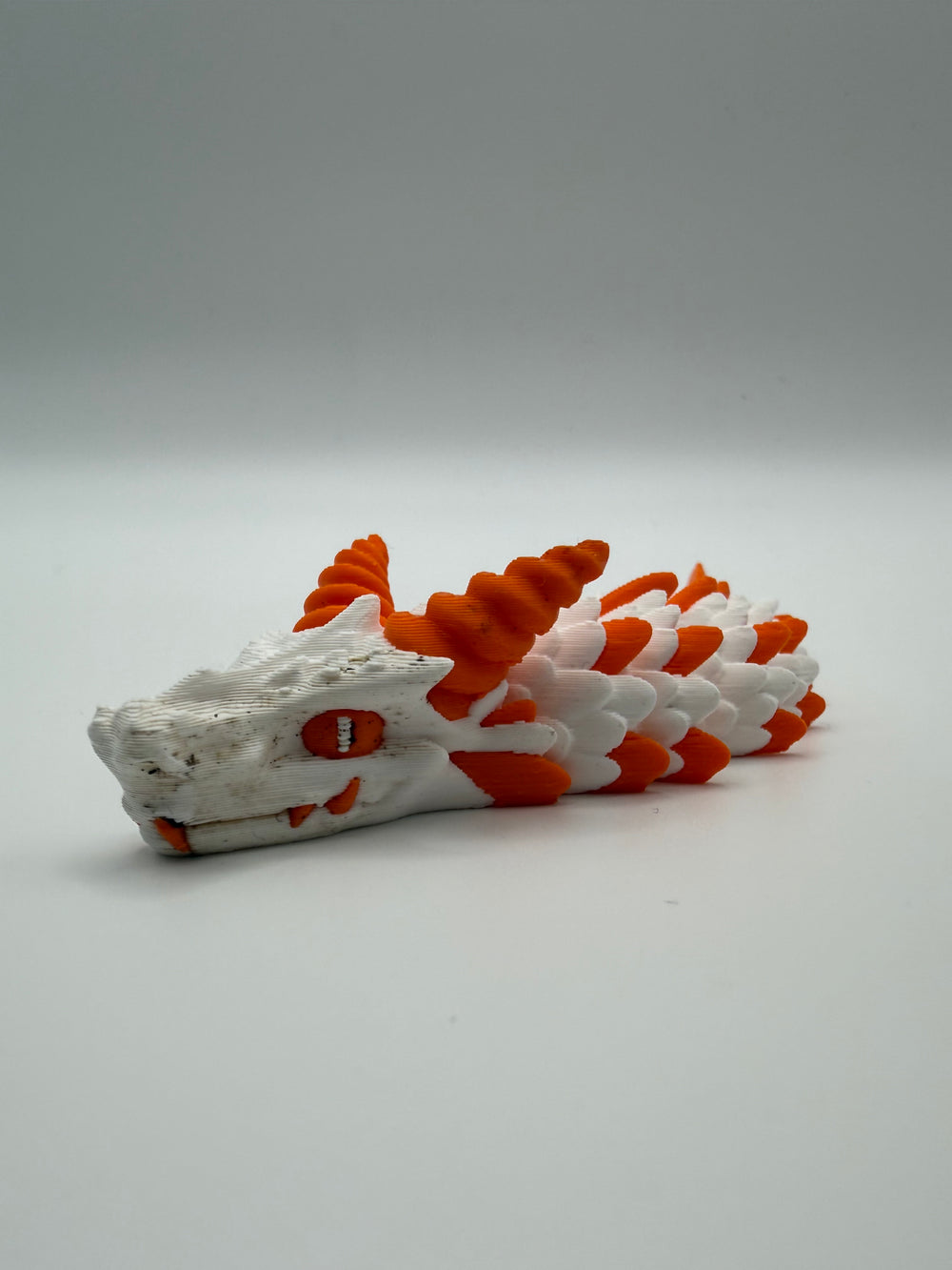 Small Dragon Flexi – White & Orange, 3D printed by 3D&ME in Tralee