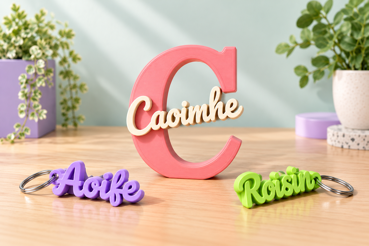 Custom 3D printed name pieces reading Caoimhe, Aoife and Roisin on a wooden counter